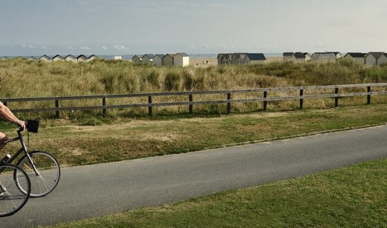 Couple cycling along the Calvados coast