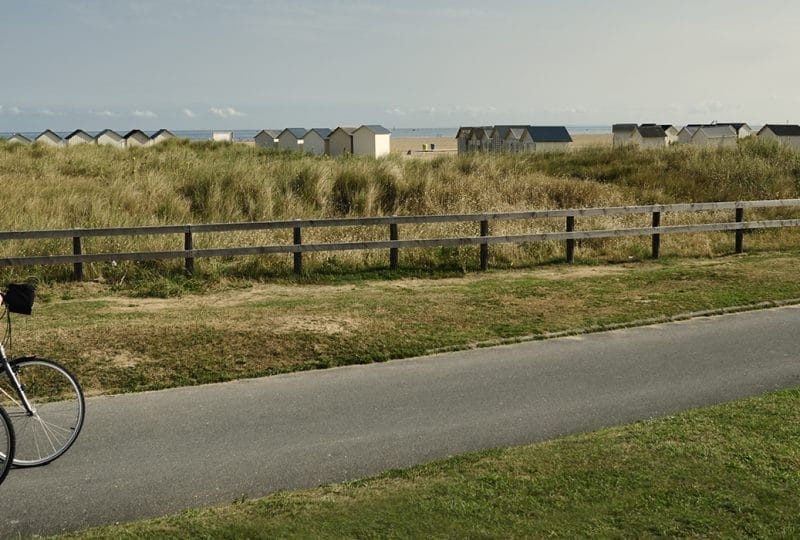 Couple cycling along the Calvados coast